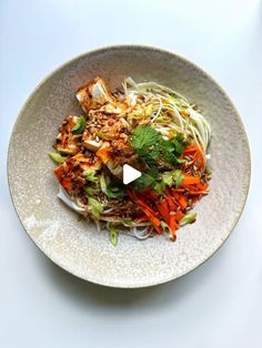 a white bowl filled with food on top of a table