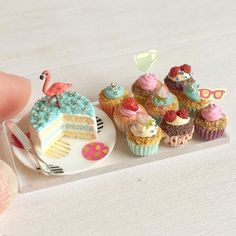 miniature cupcakes and cakes on a plate with a fork in front of them