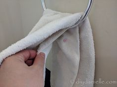 a person is holding a towel on a rack