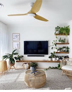 a living room filled with furniture and a flat screen tv mounted on a wall above a wooden coffee table