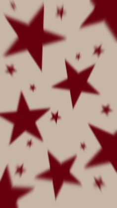 many red stars are flying in the air with their shadows on it's surface