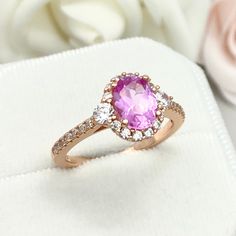 This beautiful ring is made 14K Solid Rose Gold With Rhodium plating. Ring details- -The Main stone is an oval cut 8mm by 6mm Lab Created Pink Sapphire Stone -Side stones are 3mm and 1mm Round simulated diamonds -Ring is casted in 14K Solid Rose Gold With Rhodium plating ( 14K yellow gold and White Gold also available, please check the drop down menu for more options) -The Total face height of the ring measures 10mms and the band width measures 1.5mms -Each ring is handmade and made to order, so Pink Oval Halo Ring For Anniversary, Oval Pink Gold Jewelry For Anniversary, Rose Gold Oval Gemstone Rings, Pink Oval Rings For Proposal, Oval Pink Gold Jewelry For Anniversaries, Oval Rose Gold Gemstone Ring, Pink Oval Rings For Anniversary, Oval Pink Proposal Ring, Oval Rose Gold Rings For Proposal