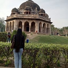 a woman standing in front of a large building