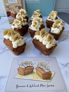 some banana and walnut mini loaves are sitting on a table next to a card