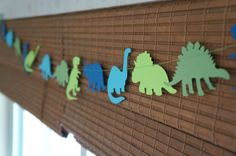 the dinosaur garland is hanging on the window sill