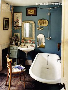 a bath room with a sink and a bath tub next to a mirror on the wall