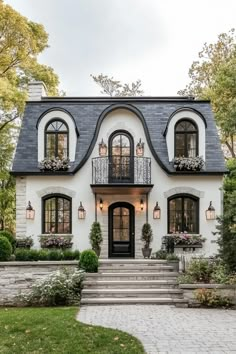 a white and black house with lots of windows