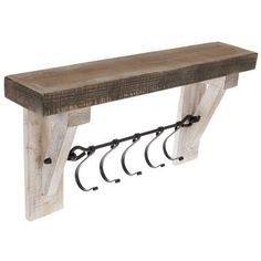 a wooden bench with four hooks on it