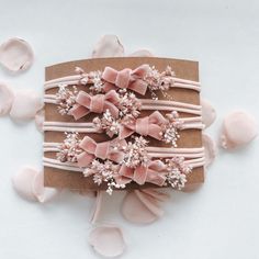 a bunch of hair clips on top of a piece of paper with bows and flowers