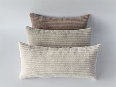 three pillows in different colors and sizes