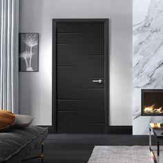 a living room with marble walls and black doors in the center, along with a fireplace