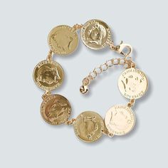 Faux 22mm Coin Bracelet in 14kts of Gold Plated AVAILABLE NOW Your selection is available for immediate purchase online and in our stands. 10 layers of Gold 18kts Plated / Rose and Silver Plated Materials: Gold Plated Style: Bracelet Size:7.5" Brand Raf Rossi Gold Plated Eco-Friendly: 100% Lead & Nickel Free, anti-Allergy AVAILABLE FOR WHOLESALE FOR REGISTER CUSTOMERS Gold Tarnish Resistant Charm Bracelet, Nickel Free Gold Round Disc Jewelry, Gold Round Charm Bracelet Tarnish Resistant, Gold Tarnish Resistant Round Charm Bracelet, Gold Coin Shaped Metal Jewelry, Adjustable Gold Coin Pendant Jewelry, Gold Charm Bracelet For Anniversary, Nickel-free Gold Plated Bracelets, Gold Engraved Charm Bracelet