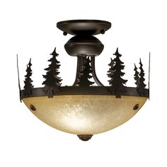 a light fixture with pine trees on it