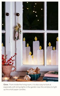 the window is decorated with candles and decorations