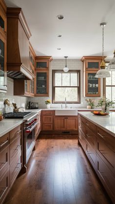 a large kitchen with wooden cabinets and white counter tops, along with hardwood flooring