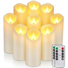 six lit candles with remote control on white background