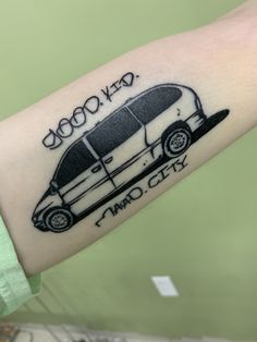 a person with a bus tattoo on their arm