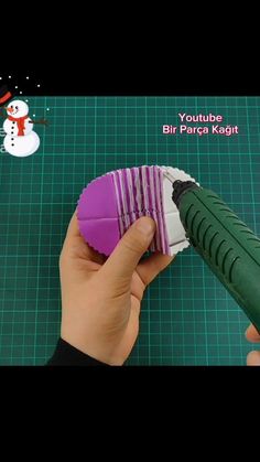 someone is making a snowman ornament out of paper