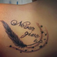 the back of a woman's stomach with an arrow and stars tattoo on it