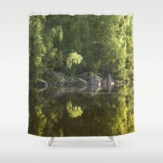 a lake with rocks and trees in the background shower curtain