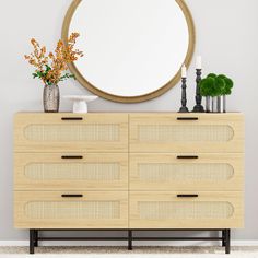 a wooden dresser with a round mirror above it