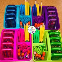 several trays filled with different colored pencils and markers