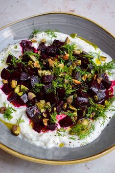 beets and yogurt with pistachio nuts on top in a bowl