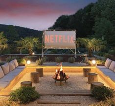 a fire pit surrounded by benches and lights