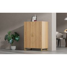 a wooden cabinet sitting in the middle of a living room next to a potted plant