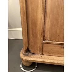 an old wooden armoire sitting on top of a floor