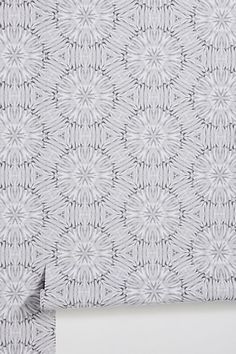 a white and grey wallpaper with an intricate design