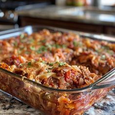 a casserole dish with meat and vegetables in it sitting on a counter top