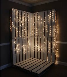 a bed made out of pallets with lights on it