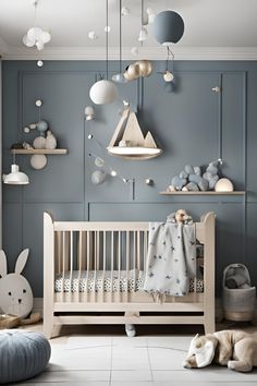 a baby's room with blue walls and white furniture, including a crib