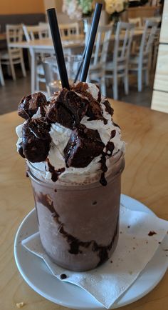 there is a chocolate drink with whipped cream and chocolate shavings in it on the table