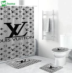 a bathroom with a louis vuitton shower curtain, toilet and rugs on the floor