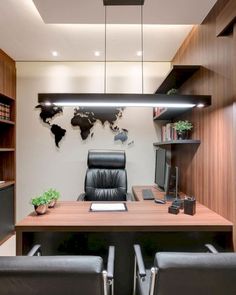 an office with black leather chairs and a wooden desk