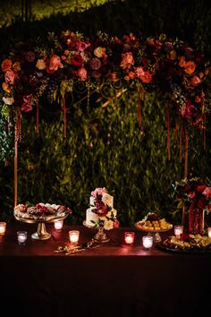 a table topped with lots of food and candles