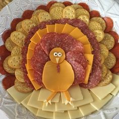 a turkey shaped platter with crackers and cheeses on the side for decoration