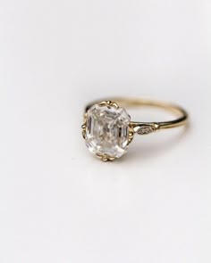 an engagement ring with a large diamond in the center and two small diamonds on each side