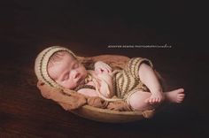 a newborn baby is sleeping in a basket