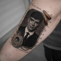 a man's arm with a portrait of him on it and a pocket watch