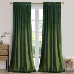 a green curtain hanging in front of a window