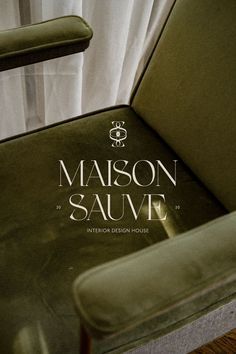 a green chair with the name maison sauvie on it's seat and back