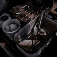 an assortment of tools sitting on top of a metal tray next to scissors and other items