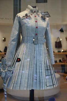 a dress made out of paper with buttons on it