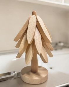 a wooden christmas tree sitting on top of a counter