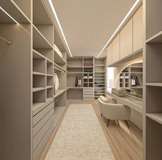 a large walk in closet with lots of shelves and drawers on the walls, along with a white chair