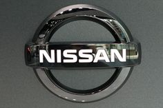 the nissan logo is displayed at an automobile show