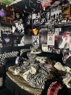 a bed room with a bunch of posters on the wall